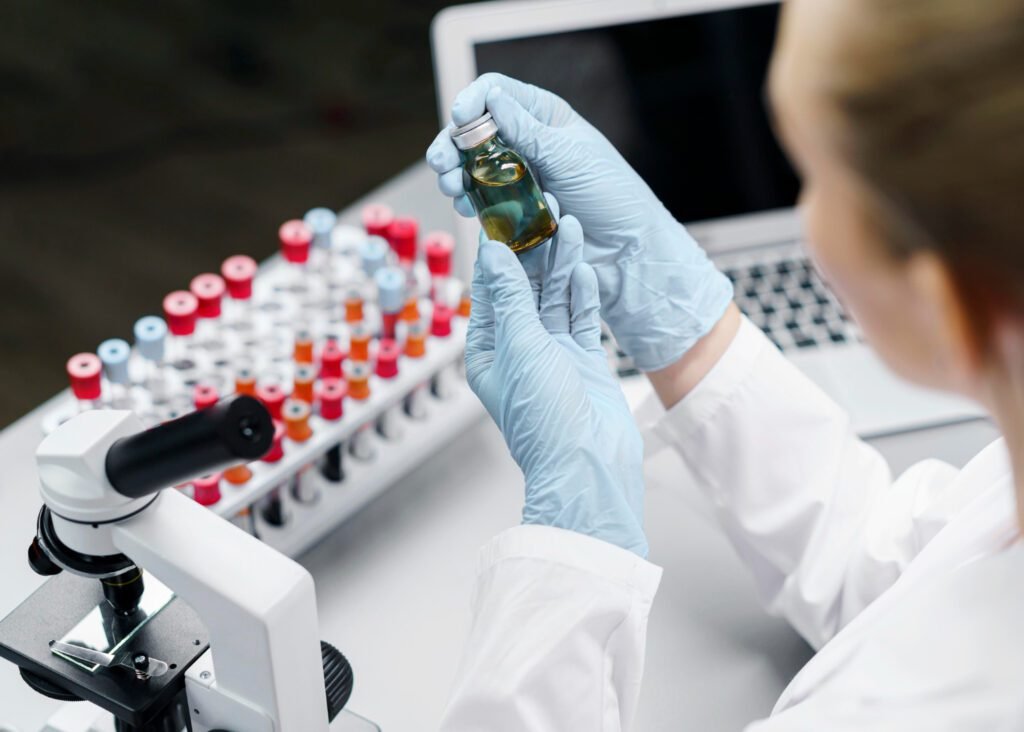 How should raw material qualification SOPs differ for biologics vs. small molecules?